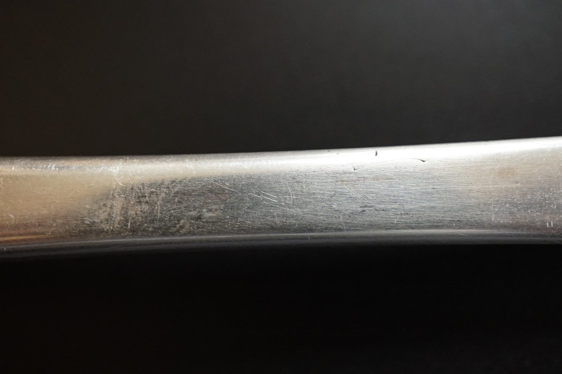 A late William III Britannia standard silver trefid spoon, by William Scarlett, London, 1701, with rat-tail bowl and later? engraved crest, 19.7cm, 52 grams.